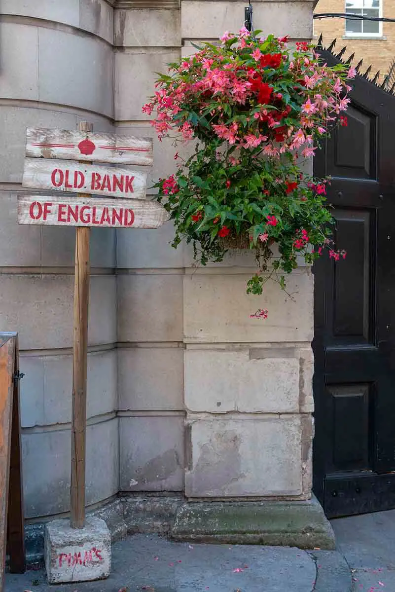 Old Bank of England Sign and Hanging Flower Baskets