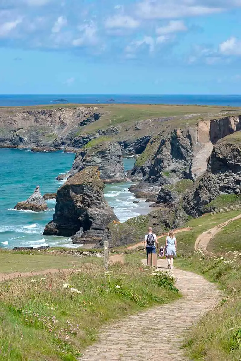 Couple Walking A Coastal Path to Stay in Shape While Traveling
