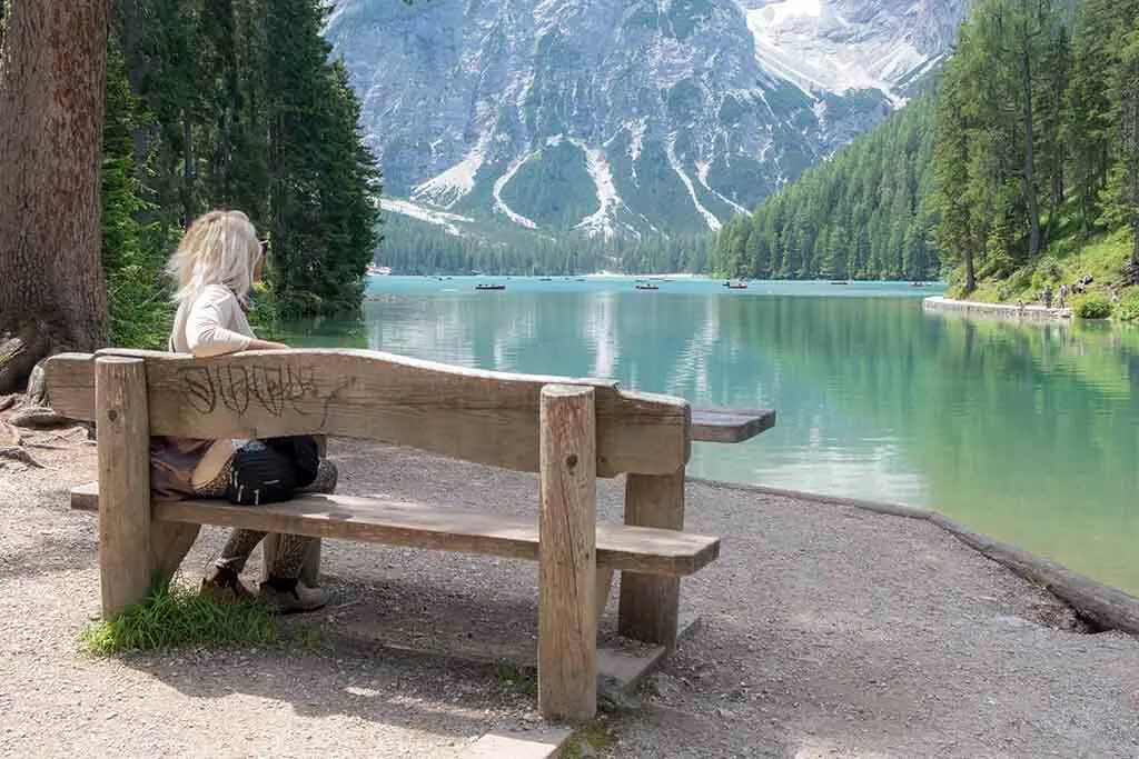 Woman Sitting On A Bench At Lago Di Braies